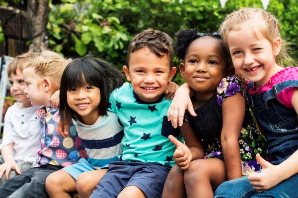 Image of six children sitting together and smiling