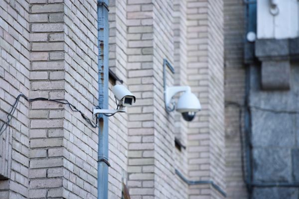 Image of two security cameras outside on a building