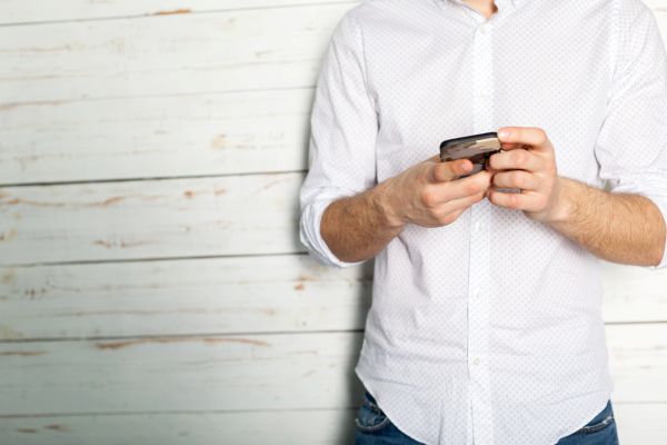cropped image of man holding his smartphone