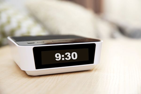 Image of modern digital alarm clock in bedroom