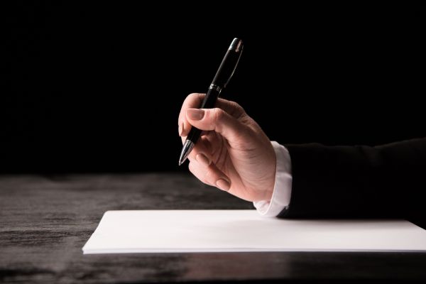 Image of a woman's hand holding a pen