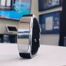 The 90-hour Mini Wrist Band Voice Activated Recorder on a white surface with a blurred indoor background